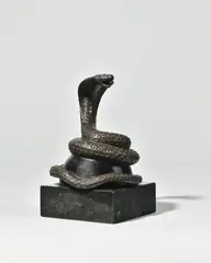 Presse-papier au serpent dressé ou enroulé by Jean Dunand, 1915, Bronze ciselé et patiné sur une demi-sphère noire et base carrée en marbre, sold Nov 2025