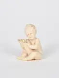 Seated boy with a cornucopia carved ivory unsigned 5 by Ferdinand Preiss, sculpture, sold Oct 2021