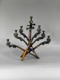 * Menorah composée de sept têtes de violon by Arman, Épreuve en bronze à patine brune, sold Dec 2021