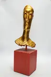 A gilt plaster model of a gentleman’s head on wooden stand by Simon Toone, sculpture, sold Apr 2024
