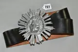 A leather belt with the buckle cast as a lady within a sun burst design by Guy Taplin, sculpture, sold Nov 2021