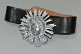 A leather belt with the buckle cast as a lady within a sun burst design by Guy Taplin, sculpture, offered Oct 2021
