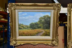 A British country landscape with woodlands to the mid by Lesley Hammett, oil on board, sold Oct 2021