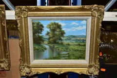 A river landscape with cottage to the distance by Lesley Hammett, oil on board, sold Oct 2021