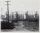 BIRMINGHAM, ALABAMA STEEL MILL AND WORKERS' HOUSES PHOTOGRAPHIC IMAGE by Walker Evans, Gelatin silver print, sold Jun 2024