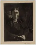 THE KNITTER / QUILTER PENNSYLVANIA PHOTOGRAPHIC PORTRAIT by Doris Ulmann, oil emulsion print depicting an older woman sitting with her hands clasped on her lap, sold Jun 2024