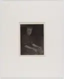 BLACKSMITH NEW ENGLAND PHOTOGRAPHIC PORTRAIT, platinum print on tissue paper depicting a sitting man wearing an apron and holding a pipe in left hand by Doris Ulmann, pencil signature ", sold Jun 2024