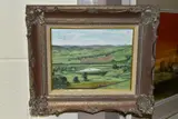 An extensive landscape with a lake to the middle distance by Nigel Hallard, oil on canvas, sold May 2021