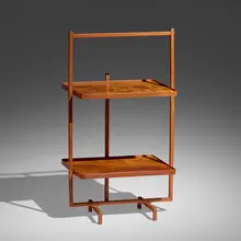 Folding occasional table by Jacques Adnet, c. 1950, leather over steel, mahogany, sold Jan 2023