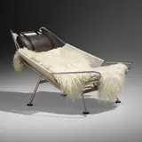 Flag Halyard lounge chair by Hans J. Wegner, c. 1950 / 2006, chrome-plated steel, flagline, upholstery, sheepskin, rubber, sold Jan 2023