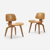 DCW, pair by Charles and Ray Eames, walnut plywood, rubber, sold Jan 2023