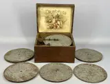 inlaid walnut case, playing 22cm discs, lithograph to interior of lid, by Monopol Disc Musical Box, lithograph, sold May 2024
