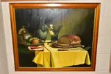 still life table setting with bread, fruit and wine, signed and dated by Bogdan Magnuski, 1989, oil on canvas, sold Feb 2021