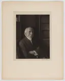 NEW YORK GENTLEMAN PHOTOGRAPHIC PORTRAIT by Doris Ulmann Jaeger, platinum print on tissue paper depicting a man with his arms crossed sitting in a library, sold Dec 2023