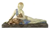 An Art Deco ceramic group of a reclining beauty with a kid by Armand Godard, sculpture, sold Oct 2023