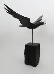 Crow flying with an egg in its mouth Signed and titled Painted wood with glass by Guy Taplin, sculpture, sold Dec 2019