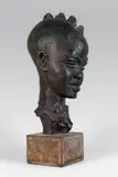 Tête d'africain by Paul Sersté, Epreuve en terre cuite à patine brun rouge nuancé signée, sold Oct 2014