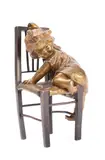 Climbing Down: a bronze figure group of a young girl climbing off a chair by Juan Clara, bronze, offered Jul 2022