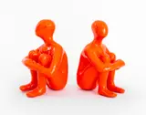 Seated Male Figures by Two Ancizar Marin, 2017, Mixed Media Sculptures in orange, sold Mar 2024