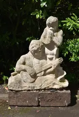 A sculpted stone garden sculpture group of a guitarist and piper by Simon Verity, sculpture, sold Jun 2022