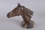 A PATINATED BRONZE BUST OF THE RACEHORSE AUTOCRACY, mounted on an Italian Portoro Nero base by William Newton, BRONZE, sold Feb 2025