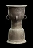 EAST INDONESIA, possibly 18th or 19th century by Kettle Drum Moko, bronze, hourglass shape with four handles, decorated with motifs of kala face and protruding tongue in lozenge shape, sold Oct 2013