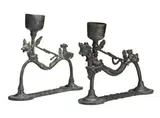 Bali by Two Lamps, bronze, each with a cup-shaped container for oil rising from a curved supporting frame ending in two legs attached to a, sold Oct 2013