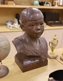 A carved walnut bust of a young Japanese boy by George Henry Paulin, sculpture, sold Dec 2022