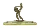 Woman holding a disc, patinated bronze figure on green onyx desk base with two pen holders by Josef Lorenzl, bronze, sold Mar 2018