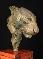 Leopard head by Michael Canadas, bronze mounted on a timber base, sold Dec 2023