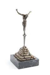 bronze "Christ de Saint Jean de la Croix" depicting Christ on the cross standing on a Roman nail held by stacked stones by Salvador Dalí, marble base, sold Apr 2023