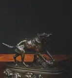 Chien jouant avec une balle by Arthur Waagen, Épreuve en bronze à patine brune, sold Dec 2024