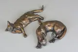 a bronze sculpture of a preening Cat lying down, initialled P.J, by Paul Jenkins, bronze, sold Apr 2018