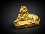 Lion couché by Prosper Lecourtier, Epreuve en bronze à patine doré signé sur la terrasse, sold Oct 2024