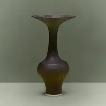 Bottle vase with flaring lip by Lucie Rie, c. 1980, glazed porcelain with sgraffito decoration, sold Jul 2026