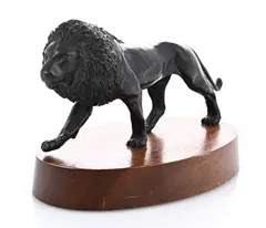 prowling lion on a wooden base by Keith Calder, bronze, sold Jul 2025