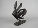 Running Hare, a limited edition bronze sculpture on an oval base, No.26/65, initialled to base, height approximately 18cm x length of base 16cm by Paul Jenkins, bronze, sold Jan 2018
