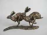 RUNNING HARES, a bronze sculpture of two hares, signed to top of by Paul Jenkins, bronze, sold Jan 2018