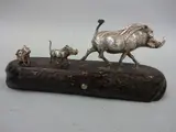 a silver sculpture modelled as three Warthogs walking, set on naturalistic hardwood base, monogrammed PM, approximately 18cm x 8cm high by Patrick Mavros, sculpture, sold May 2016