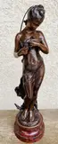 Jeune femme à la colombe by Hippolyte Moreau, Bronze à patine brune sur un socle en marbre griotte, sold May 2023