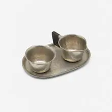 Creamer and sugar set by Karl Raichle, c. 1935, pewter, ebony, sold Aug 2022