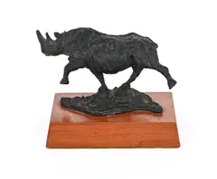 Untitled by Keith Calder, bronze charging rhinoceros on a wooden base, sold Mar 2026