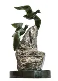 A green nephrite carving of two Ducks Flying by Lyle Sopel, Stone Base, offered Jul 2019