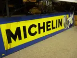 rectangular lithograph and enamelled showing image of 'Bidendum', 46 x 197 cms by Michelin Tyres Sign, lithograph and enamelled, sold Oct 2016