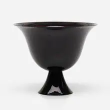 Footed bowl by Murano, c. 1925, dark amethyst glass, sold Aug 2022