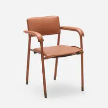 Armchair by Jacques Adnet, c. 1950, vinyl, brass, sold Aug 2022