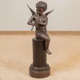 Untitled by Joseph Giuseppe D'Aste, bronze of a putto seated on a partial column playing a pipe, sold Mar 2026