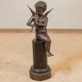 Untitled by Joseph Giuseppe D'Aste, bronze of a putto seated on a partial column playing a pipe, sold Mar 2026