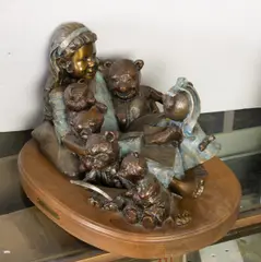 Girl with Bears by Blair Muhlestein, bronze sculpture on wooden base, sold Jun 2025