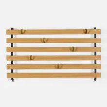 Wall-mounted coat rack by Carl Auböck, c. 1945, laminate over wood, brass, enameled steel, sold Jul 2022